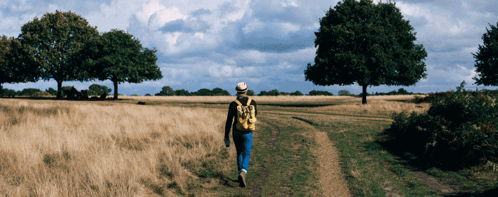 Man with backpack on a trail starting on a journey