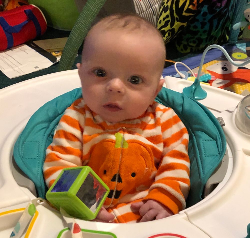 baby sitting in a play saucer chair 